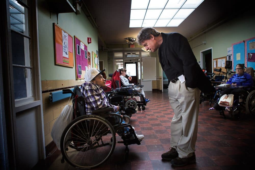 Brian Devin, CEO of The Massachusetts Hospital School, speaks with student Miguel M. in the cafeteria after lunch. (Jesse Costa/WBUR)