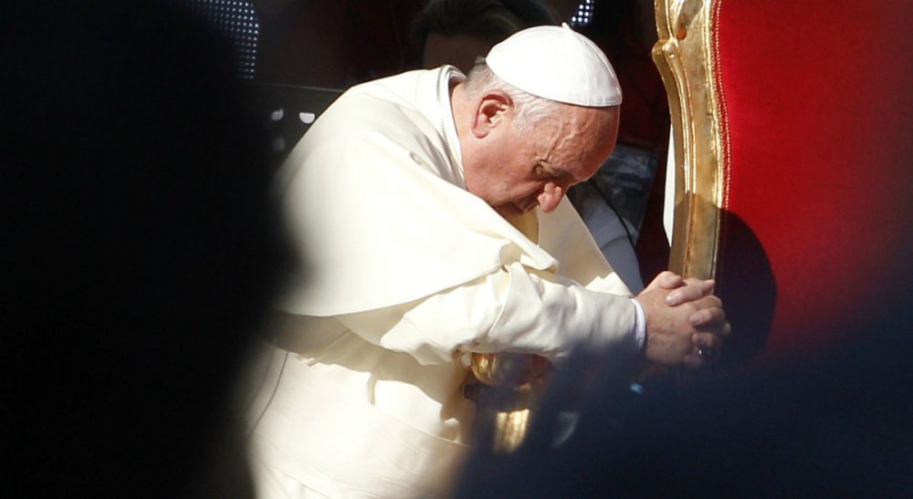 Pope Francis prays during a meeting with faithful at Rome's Olympic Stadium, Sunday, June 1, 2014. Pope Francis has led a pep rally to boost faith at Rome's soccer stadium, packed with more than 50,000 Catholics who follow charismatic movements. (Riccardo De Luca/AP)