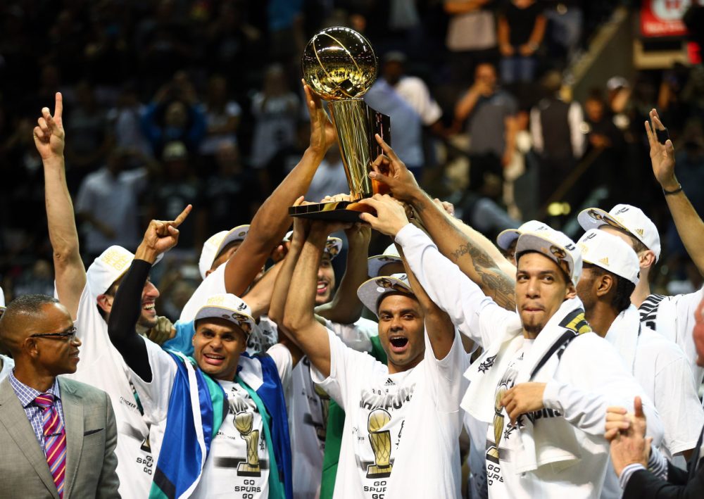 The San Antonio Spurs celebrate with the Larry O'Brien trophy after defeating the Miami Heat to win the 2014 NBA Finals. (Andy Lyons/Getty Images)