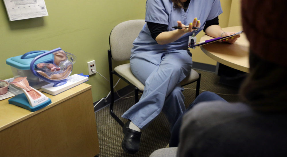Jacqui Morton: I wish we could support each other rather than fight over lines on the sidewalk. Pictured: A medical clinician interviews a patient at a Planned Parenthood location in Boston. On Thursday, June 26, 2014, the Supreme Court unanimously struck down a Massachusetts law that prohibits abortion protests any closer than 35 feet from the entrance to clinics.(Steven Senne/AP)
