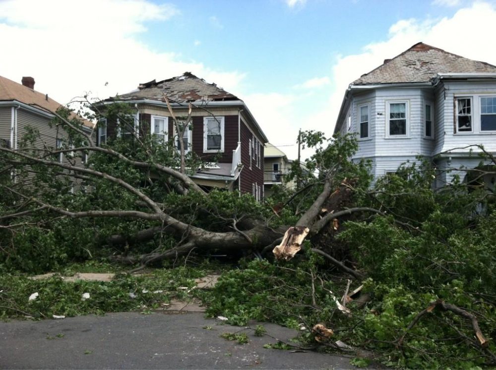 People survey damage in front of a funeral home in Revere Monday, July 28 after a tornado touched down. (Elise Amendola/AP)