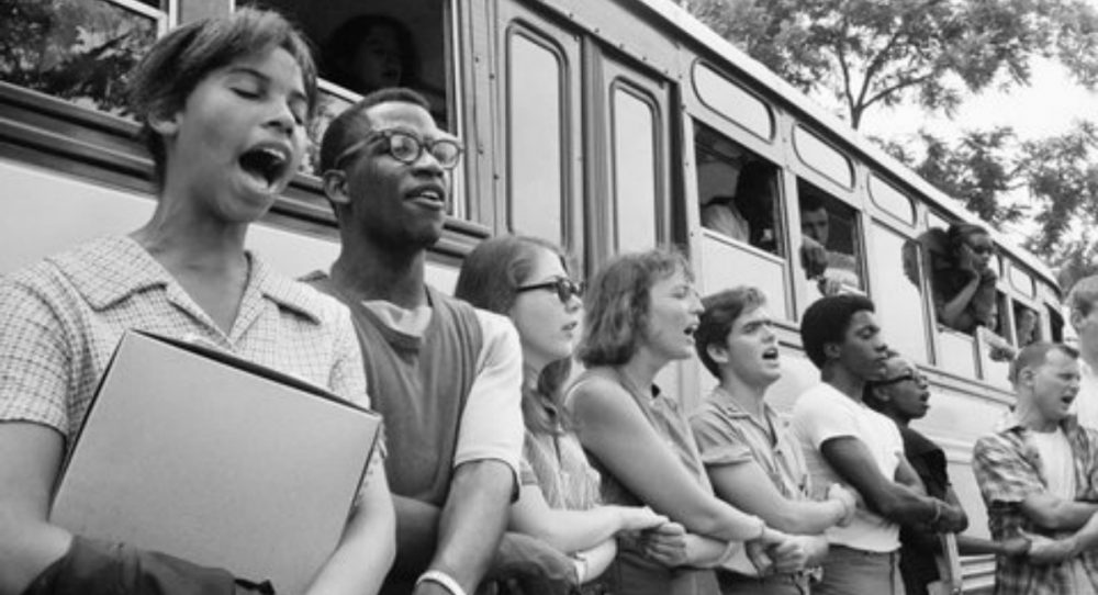 J. Kates: "Fifty years later, the significance of 'Freedom Summer,' the Mississippi Voting Project of 1964, gets measured not by our accomplishments, but by our losses." Pictured: The author, fifth from left, and fellow volunteers sing beside their bus in Oxford, Ohio, in June 1964 before leaving for Mississippi to help blacks register to vote. (Ted Polumbaum/Newseum collection. Used by permission)