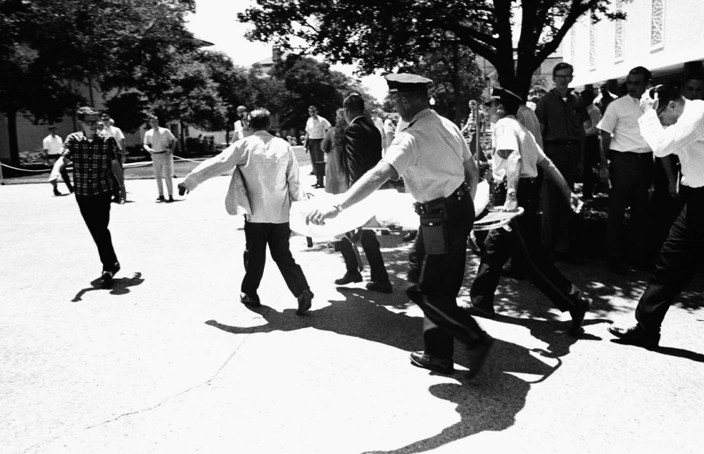 One of the victims of Charles Joseph Whitman, the sniper who gunned down victims from a perch in the University of Texas tower, is carried across the campus to a waiting ambulance, Aug. 1, 1966 in Austin. The unidentified victim was gunned down inside the tower, according to police on the scene. (AP)