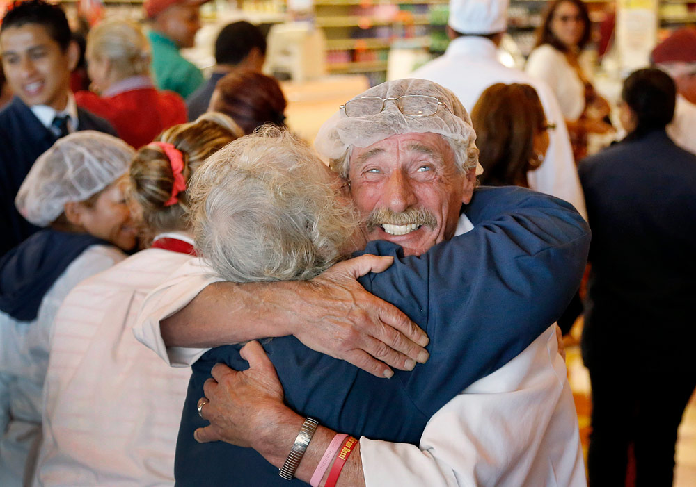 Market Basket meat manager Bob Dietz hugs cashier Mary Olson Thursday in the Chelsea store after watching Arthur T. Demoulas’ speech. (Steven Senne/AP)