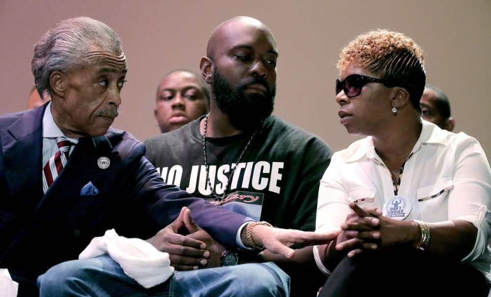 Rev. Al Sharpton, left, speaks with parents of Michael Brown, Michael Brown Sr. and Lesley McSpadden, right, during a rally at Greater Grace Church, Sunday, Aug. 17, 2014, for their son who was killed by police last Saturday in Ferguson, Mo. Sharpton told the rally Brown’s death was a "defining moment for this country." (AP)