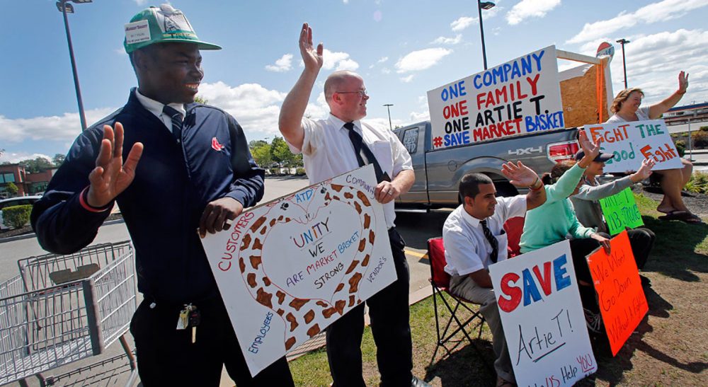 The recent Market Basket dispute demonstrates that America's labor law is in dire need of reform. Pictured: Market Basket employees hold signs and wave to passing supporters outside the supermarket in Haverhill, Mass., Monday, Aug. 18, 2014. (Elise Amendola/AP)