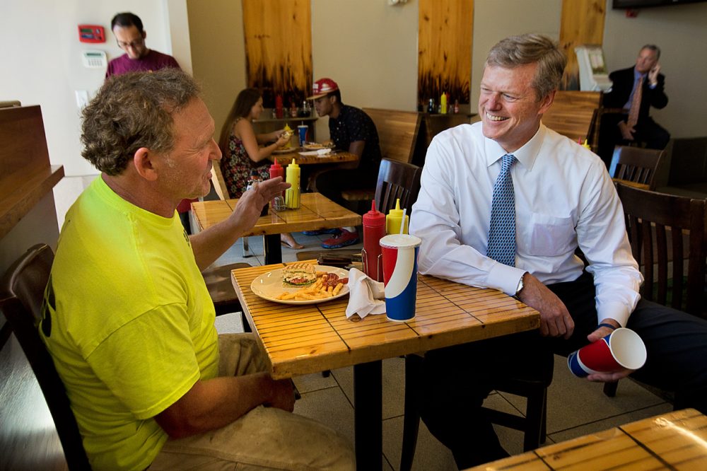 Republican Charlie Baker, right, stops by Eagle's Deli in Boston Thursday. (Jesse Costa/WBUR)