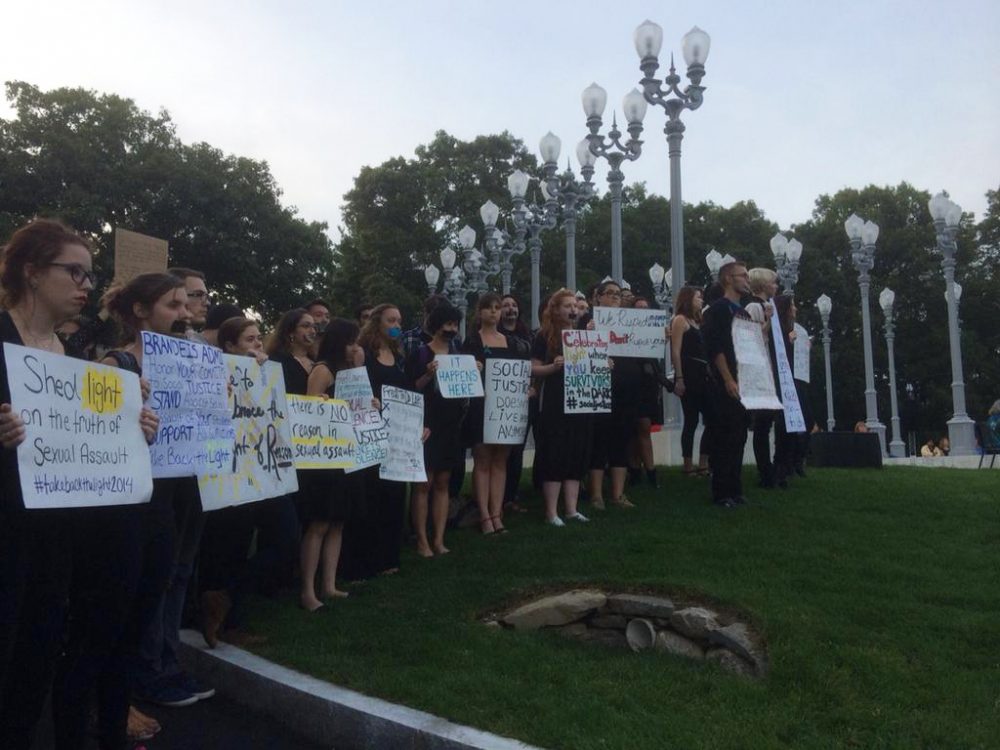 A group of Brandeis students stood before hundreds during a public demonstration to raise awareness about sexual assault. (Fred Thys/WBUR)