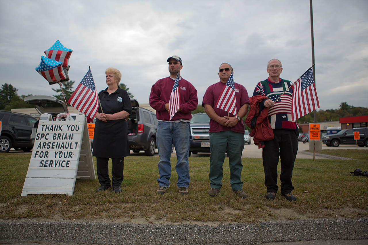 Dozens of people waving American flags lined the procession route from the church to the Howard Street Cemetery. (Jesse Costa/WBUR)