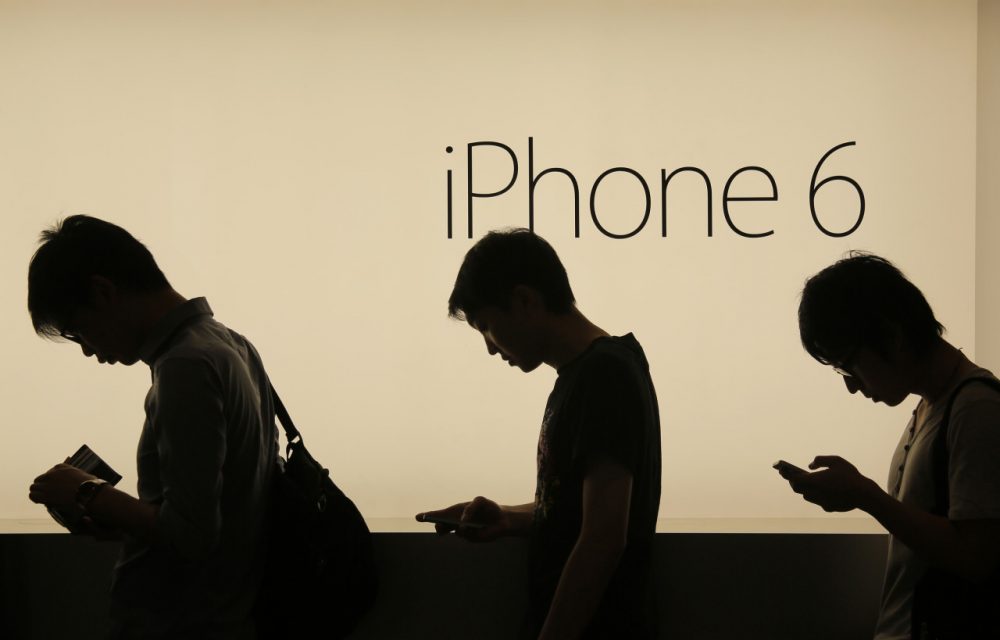 In this photo taken on Friday, Sept. 19, 2014, people wait to buy the new Apple iPhone 6 and 6 Plus devices outside an Apple store in Hong Kong. The Apple's new devices were released on Friday in Hong Kong, Singapore, Australia and Japan. (Vincent Yu/AP)