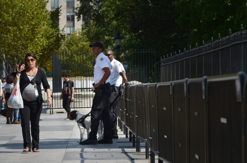 Members of the Secret Service Uniformed Division keep watch from the front of the White House on September 23, 2014. Eariler, an armed man scaled the fence and entered the residence. (Mandel Ngan/AFP/Getty Images)
