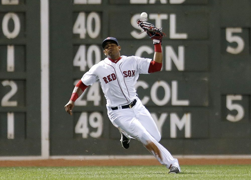 Boston Red Sox's Yoenis Cespedes misplays the fly ball by Baltimore Orioles' Adam Jones allowing a run to score during the seventh inning of a baseball game in Boston on Monday. (Michael Dwyer/AP)