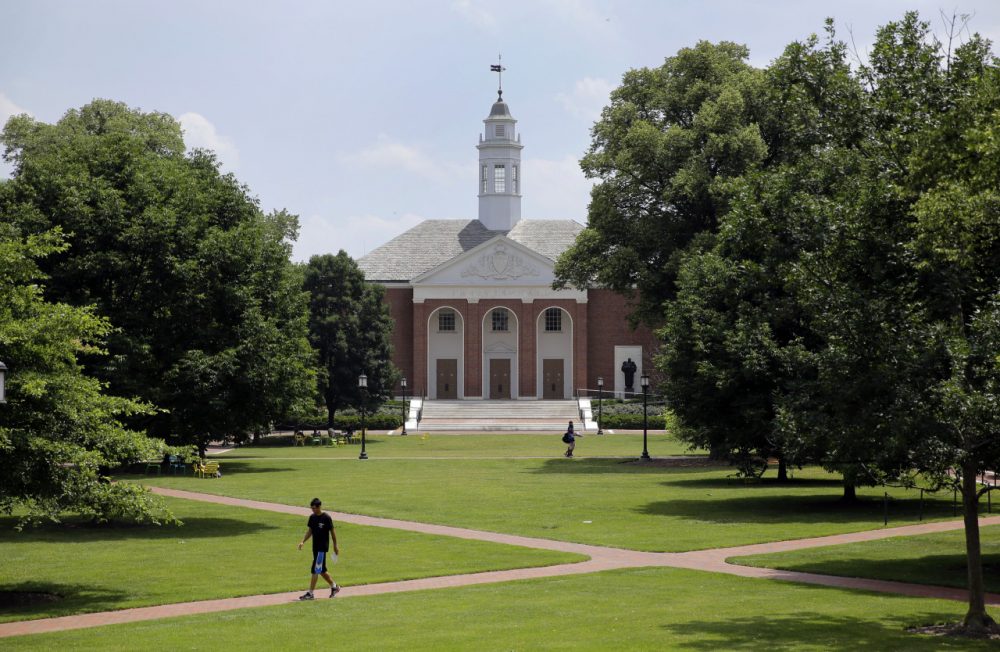 July 8, 2014 picture, people walk on Johns Hopkins University's Homewood campus in Baltimore. Johns Hopkins is under investigation for its handling of an alleged gang rape of a Towson University student at a fraternity house, Pi Kappa Alpha, in the spring of 2013. Since the allegation became public in May, Hopkins students have come out of the woodwork to share their own sexual assault stories, said Laura Dunn, an advocate with nonprofit organization SurvJustice who helped file the initial complaint. (AP)