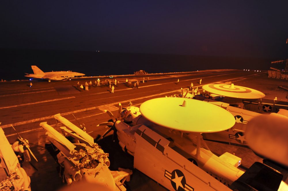 In this photo released by the U.S. Navy, A-18C Hornet, attached to Strike Fighter Squadron (VFA) 87, prepares to launch from the flight deck of the aircraft carrier USS George H.W. Bush (CVN 77) to conduct strike missions against Islamic State group targets, in the Arabian Gulf, Tuesday, Sept. 23, 2014. (Robert Burck/U.S. Navy via AP)