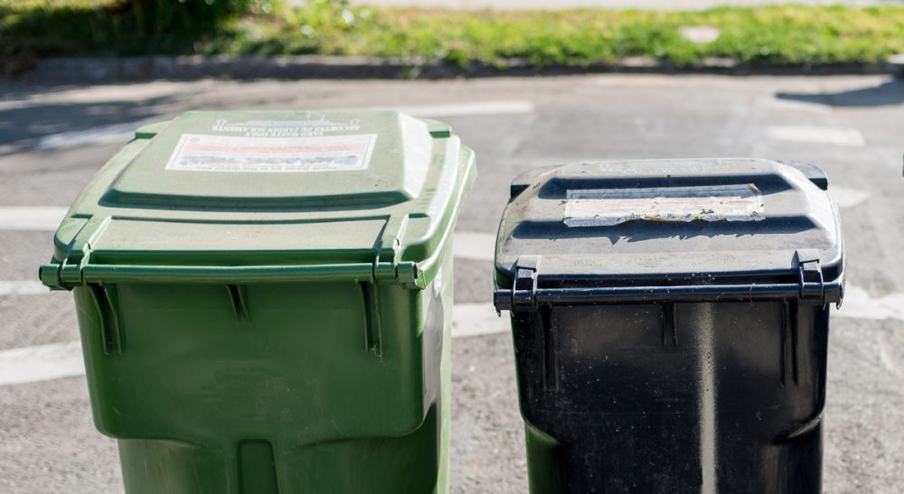 Five tenants, two trash cans, and one neighbor who doesn't want to share.(hermitsmoores/Flickr)