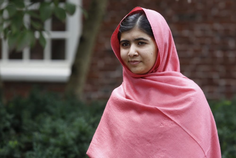 Malala Yousafzai listens as Harvard President Drew Gilpin Faust introduces her to reporters at Harvard University in Cambridge, (Jessica Rinaldi, File/AP)