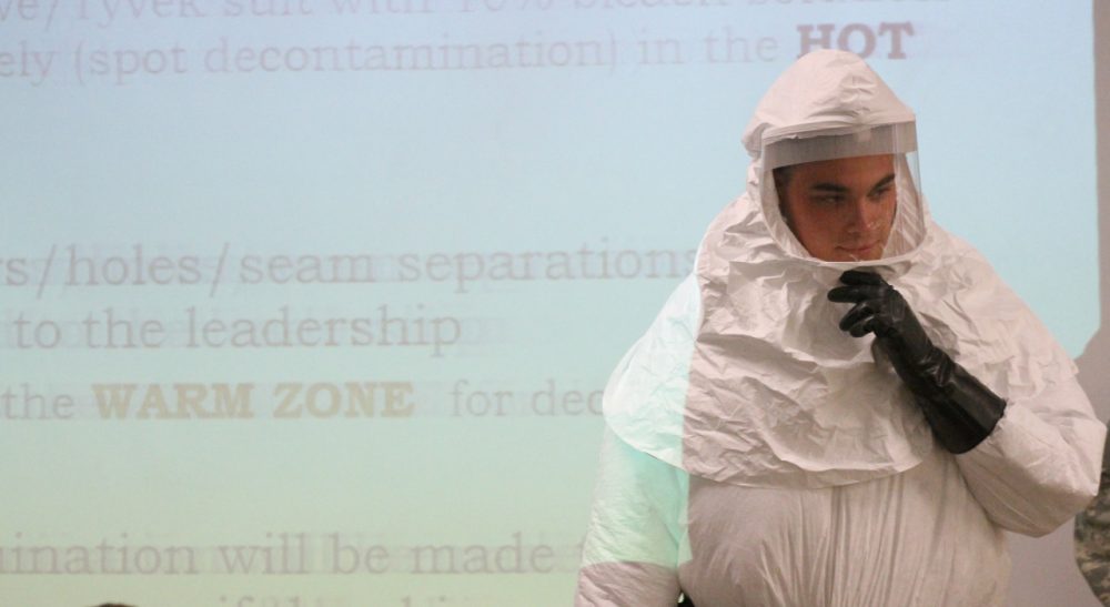 Cpl. Zachary Wicker shows the use of a germ-protective gear in Fort Bliss, Texas, Tuesday, Oct. 14, 2014. About 500 Fort Bliss soldiers are preparing for deployment to West Africa where they will provide support in a military effort to contain the Ebola outbreak. /Juan Carlos Llorca/AP)