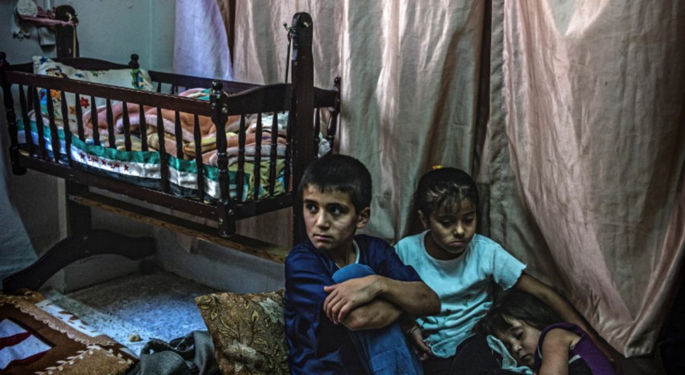 Dana Janbek: "Throughout this time of war, the cellphone fills a vacuum felt by Syrian refugees who are miles away from their homes and loved ones. It serves as a thread that helps tie their shattered lives together." Pictured: Syrian refugee children in Amman, Jordan, June 16, 2013. (UNHCR/flickr)