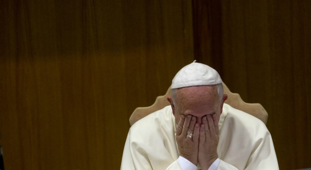 Eileen McNamara: "By what measure of rational thought is a draft document that asks about homosexuals -- and only asks -- whether the Catholic Church is 'capable of welcoming these people' a cause for celebration?" Pictured: Pope Francis rubs his face during a morning session of a two-week synod on family issues, at the Vatican, Friday, Oct. 10, 2014. Gay rights groups are cautiously cheering a shift in tone from the Catholic Church toward homosexuals. (Alessandra Tarantino/AP)