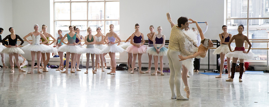 Ashley Ellis and Eris Nezha rehearse their pas de deux as corps de ballet dancers wait for their entrance during a costume run-through of "Swan Lake" at the Boston Ballet studios. (Lawrence Elizabeth Knox).