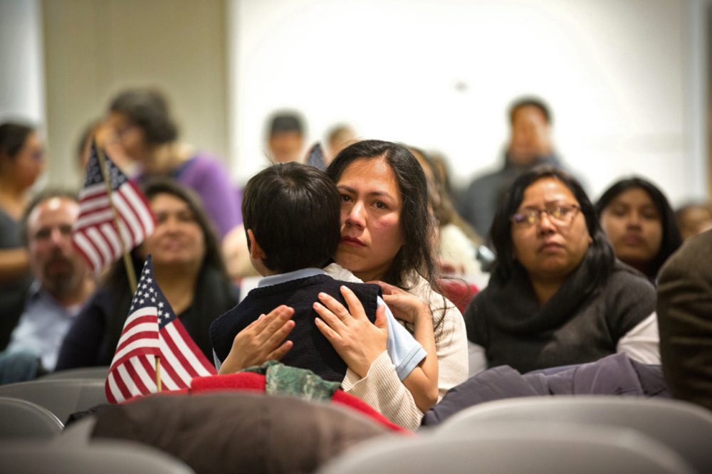 Martha Moran, with her 6-year-old son listen during a viewing party for President Barack Obama's speech on executive action immigration policy reform on November 20, 2014 in New York City. (Kevin Hagen/Getty Images)