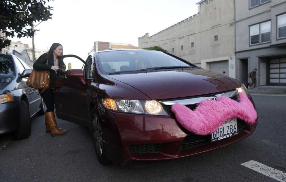 In this Jan. 4, 2013 file photo, Lyft passenger Christina Shatzen gets into a car driven by Nancy Tcheou, in San Francisco. (Jeff Chiu/AP)