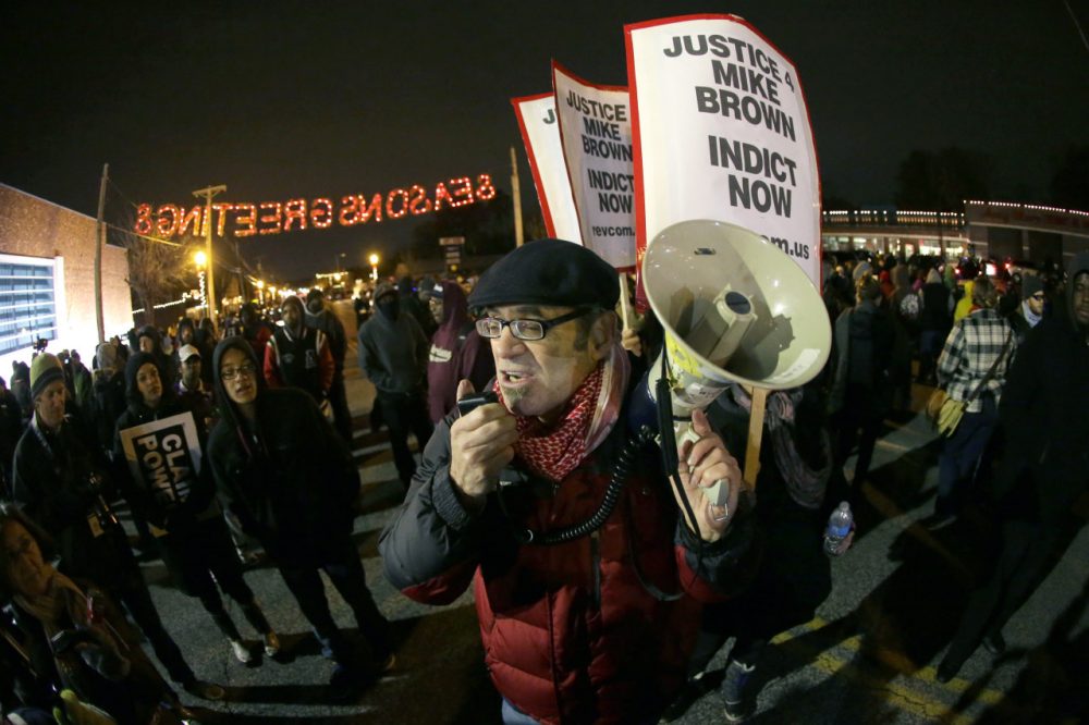 Protesters gather in front of the Ferguson Police Department before the announcement of the grand jury decision . (Charlie Riedel/AP)