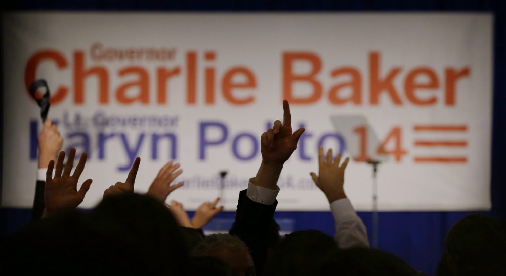 Supporters of Massachusetts Republican gubernatorial candidate Charlie Baker cheer as they watch election results come in after midnight in a race still to close to call at Baker's election night event Wednesday, Nov. 5, 2014 in Boston. (Stephan Savoia/AP)