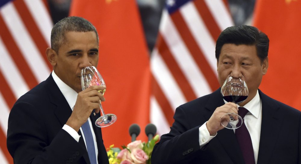 U.S. President Barack Obama, left, and Chinese President Xi Jinping drink a toast at a lunch banquet in the Great Hall of the People in Beijing Wednesday, Nov. 12, 2014. The United States and China pledged Wednesday to take ambitious action to limit greenhouse gases, aiming to inject fresh momentum into the global fight against climate change ahead of high-stakes climate negotiations next year. (Greg Baker/ AP)