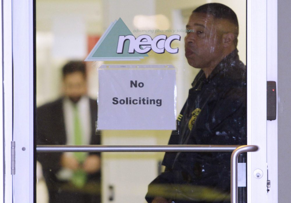 In this Oct. 16, 2012 file photo a Food and Drug Administration Agent stands at the doorway of New England Compounding Center in Framingham, Mass. (Bill Sikes/AP)