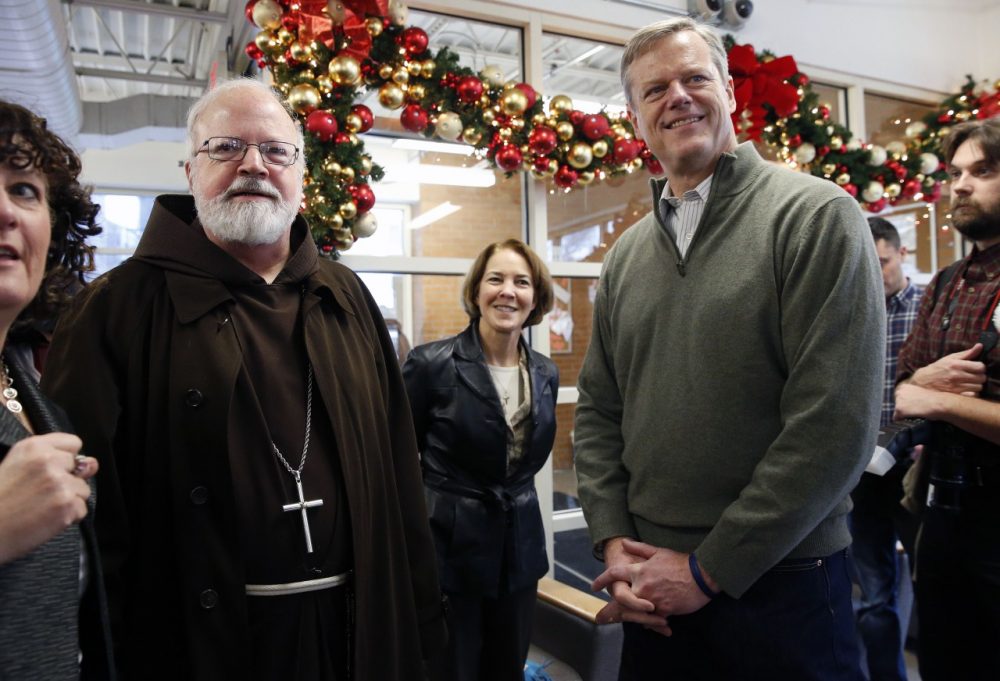 Archbishop of Boston Sean O'Malley, left, and Gov.-elect Charlie Baker stand together before serving meals at the Pine Street Inn homeless shelter in Boston on Wednesday. (Michael Dwyer/AP)