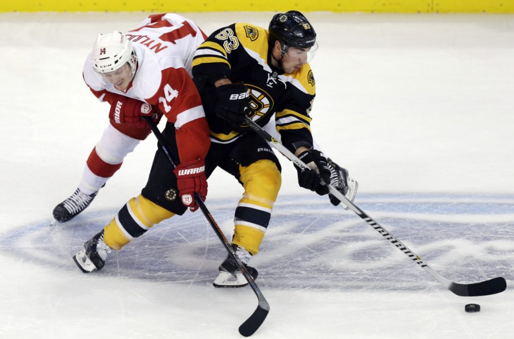 Boston Bruins left wing Brad Marchand (63) skates around Detroit Red Wings center Gustav Nyquist (14) in Boston, Monday, Dec. 29, 2014. (Charles Krupa/AP)