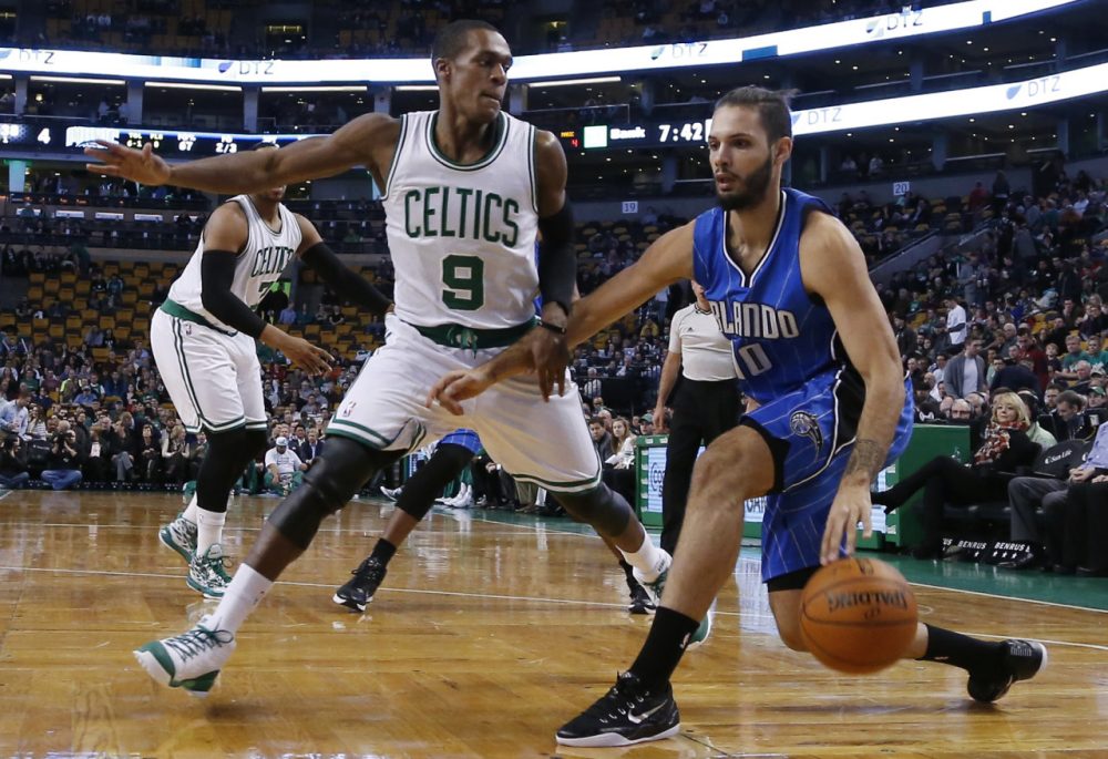Orlando Magic guard Evan Fournier (10) drives against Boston Celtics guard Rajon Rondo (9) during last night's game in Boston, Wednesday, Dec. 17, 2014. (Elise Amendola/AP)