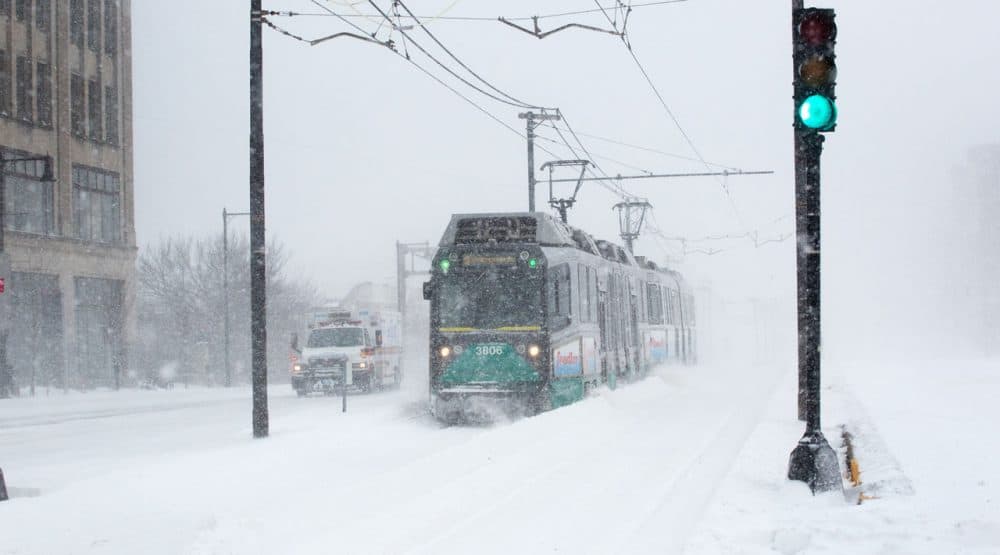 A Green Line train emerges during a recent blizzard on Commonwealth Ave. Delays and closures due to winter weather have brought renewed attention to transportation funding. (Robin Lubbock/WBUR)
