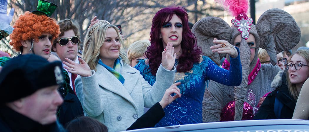 Amy Poehler rides through Harvard Square on the back of a convertible to celebrate her Hasty Pudding "Women of the Year" award. (Jesse Costa/WBUR)
