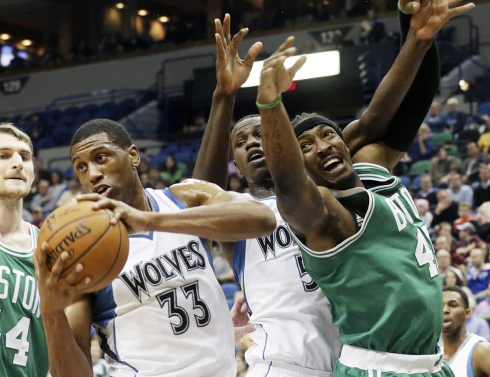 Minnesota Timberwolves Thaddeus Young, left, beats Boston Celtics Gerald Wallace, right, to the rebound during Wednesday night's game on Jan. 28, 2015, in Minneapolis. (Jim Mone)