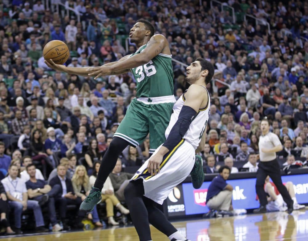 Boston Celtics guard Marcus Smart (36) lays the ball up as Utah Jazz center Enes Kanter, right, defends during Monday night's game on Jan. 26, 2015, in Salt Lake City. (Rick Bowmer/AP)
