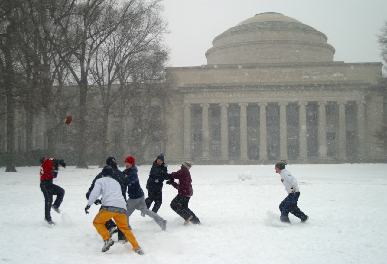 A group from the Cambridge Community Fellowship Church plays football in a blowing snowstorm in Killian Court at the Massachusetts Institute of Technology Monday, Feb. 17, 2003. MIT's Building 10, the Great Dome, is behind. The Boston area is predicted to receive between 12 to 18 inches of snow from the latest winter storm. (Daniel Bersak/AP)