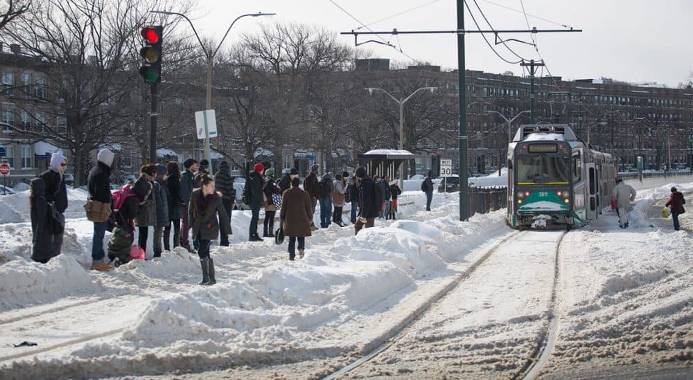 Riders wait for the Green Line along Commonwealth Avenue in Boston Tuesday. (Robin Lubbock/WBUR)