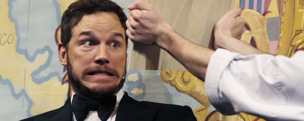 Actor Chris Pratt gets ready to break a board with his head during the roast at Harvard University, where he was honored as "Man of the Year" by the Hasty Pudding Theatricals. (Charles Krupa/AP)