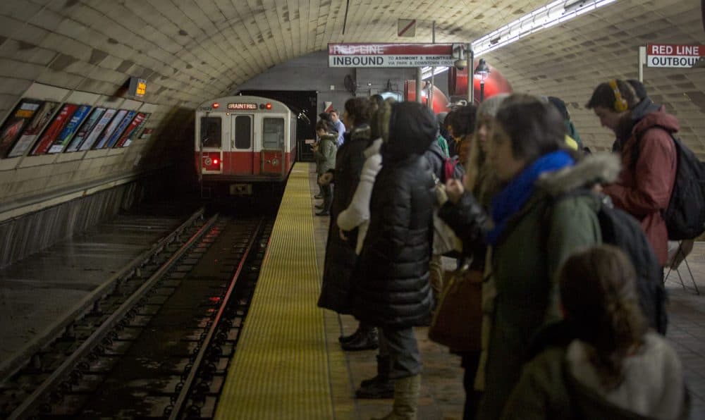 Commuters wait for the Red Line in Cambridge's busy Porter Square station Wednesday morning. MBTA rail service is up again, but it's running a limited schedule. (Robin Lubbock/WBUR)