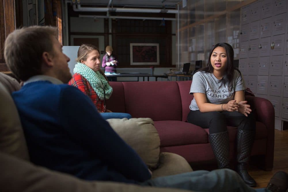 At Lowell's United Teen Equality Center, Ginny Chhuon, 21, right, talks with Elizabeth Porrazzo, a transitional coach, and Geoff Foster, director of organizing and policymaking. “I think I probably would be homeless if I didn’t find this place,” Chhuon says of UTEC. (Jesse Costa/WBUR)