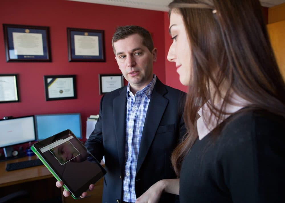 Harvard psychology professor Matt Nock and research assistant Nicole Murman demonstrate the Implicit Association Test related to suicide risk. (Robin Lubbock/WBUR)