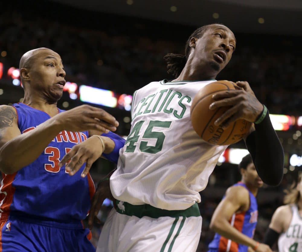 Detroit Pistons forward Caron Butler (31), and Boston Celtics forward Gerald Wallace (45), grapple over a loose ball in the second quarter Sunday's game. (Steven Senne/AP)