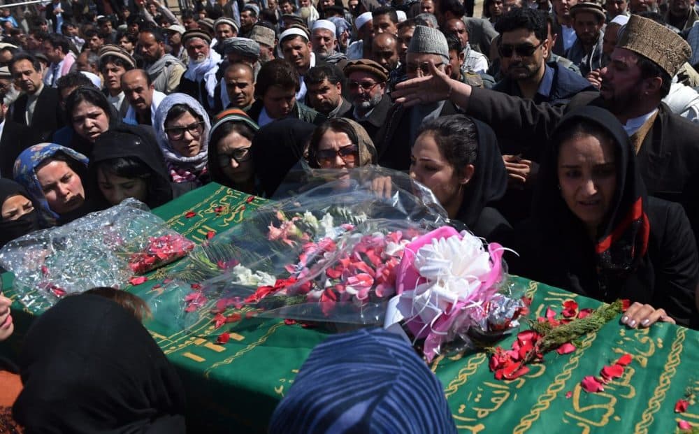 Hundreds of people attended the burial of an Afghan woman on Sunday. She was beaten to death and set on fire by a mob for allegedly burning a copy of the Qur'an. (Wakil Kohsar/AFP/Getty Images)