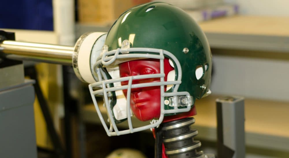 Bill Littlefield says despite mounting research, statistics and growing scientific concern about the link between football and brain disease, it appears the attitude of the NFL is the same as it ever was. This photo, provided by the Southern Impact Research Center in Tennessee, taken June 18, 2014, shows equipment that can test how football helmets perform against certain concussion-causing forces. There is no concussion-proof football helmet, but an organization that sets safety standards for athletic equipment was preparing new testing criteria. (AP)