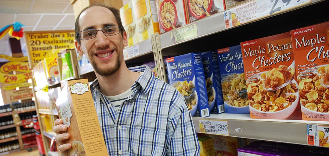 Brian Friedland, a composer who puts text
from product packaging to music, scours the cereal aisle at a Trader Joe's. (Andrea Shea/WBUR)