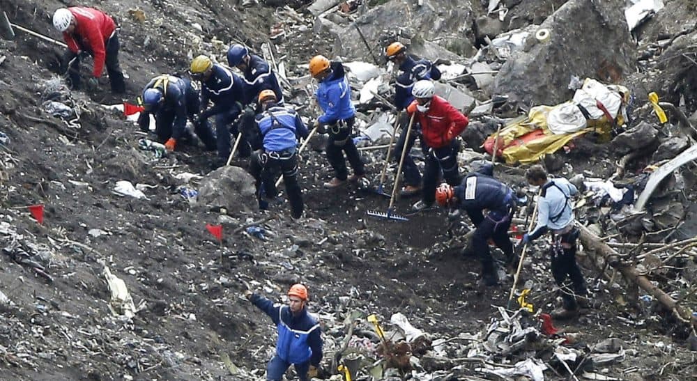 Tom LeCompte: "Who’s going to land the plane if things go wrong? We already ride on trains without engineers and are preparing for driverless cars. Why not pilotless airliners?" Pictured: Rescue workers work on debris of the Germanwings jet at the crash site near Seyne-les-Alpes, France, Thursday, March 26, 2015. The co-pilot of the Germanwings jet barricaded himself in the cockpit and “intentionally” rammed the plane full speed into the French Alps, ignoring the captain’s frantic pounding on the cockpit door and the screams of terror from passengers, a prosecutor said Thursday. In a split second, he killed all 150 people aboard the plane. (Laurent Cipriani/AP)