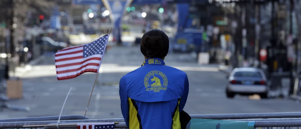 A woman pauses near the barricades blocking off Boylston Street in the days after the 2013 Boston Marathon bombings. (Matt Rourke/AP)