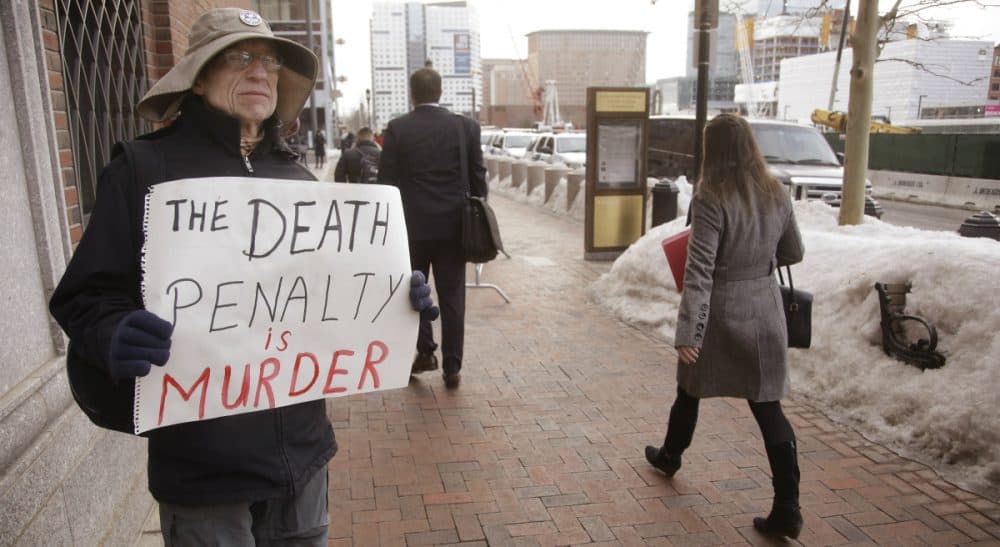 Harvey Silverglate: It’s tempting to believe that Dzhokhar Tsarnaev deserves to have entire weight of the country’s prosecutorial might bearing down on him. But does it help our community heal? In this photo, Joe Kebartas of South Boston holds anti-death penalty sign as he stands next to the federal courthouse Monday March 9, 2015, in Boston, during the federal death penalty trial of Tsarnaev. (Stephan Savoia/AP)